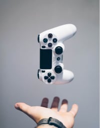 hand placed under a playstation 4 pad in the air